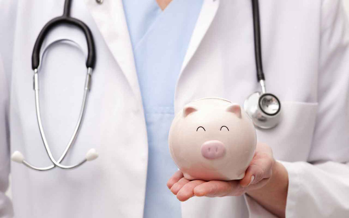 Doctor holding piggy bank